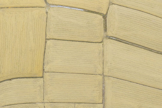 Aerial view of tilled agricultural fields with geometric patterns and earthy textures waiting for spring planting in Taiwan.