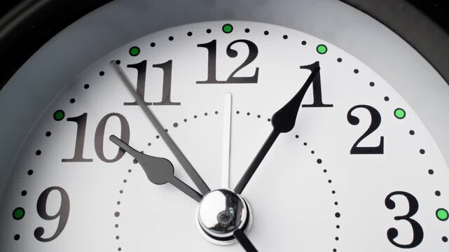 Old fashioned alarm clock with bells. Vintage clock time flowing. Clock face on white background. Time concept. Table clock show running time. Close-up in 4K, UHD