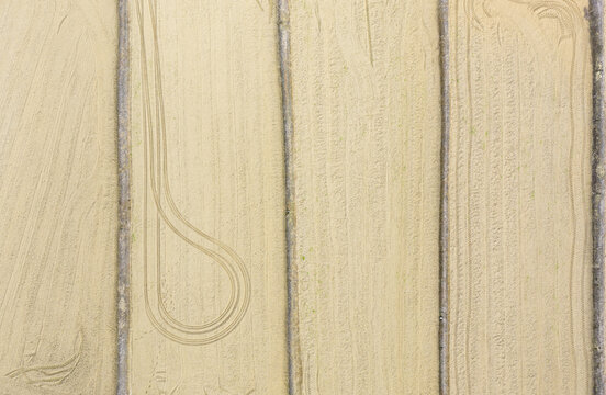 Aerial view of tilled fields with tire tracks and vertical furrows waiting for spring planting Taiwan.
