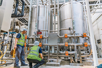 Fototapeta premium Male work inspection process valve control at the process area of the pipeline, flowing stainless steel chemicals in a factory