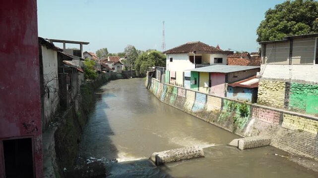 Polluted River Canals Through Settlements In Banyuwangi, East Java, Indonesia. Static Shot 