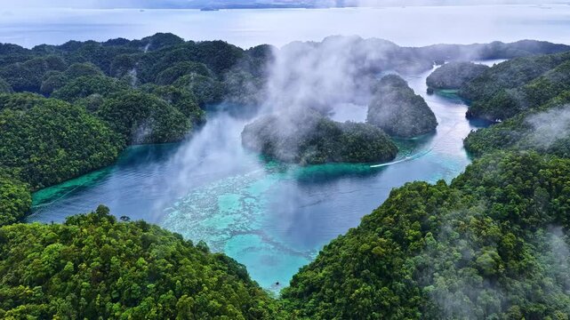 Wispy Clouds Over Lush Greenery Of Sohoton Cove On Bucas Grande Island In The Philippines. Aerial Shot