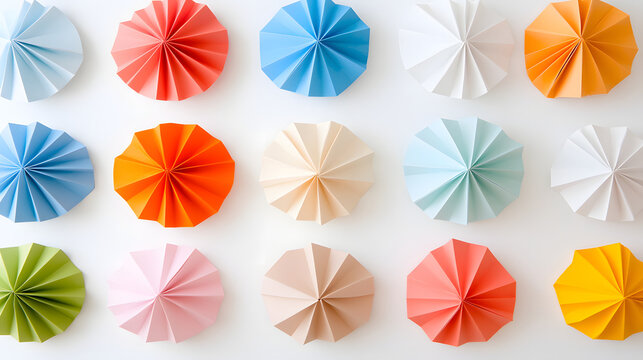 Paper rosette colorful pastel geometric origami craft decoration flat lay of multicolor folded paper rosettes white background, repeating circle pattern for festive party decor, minimal modern