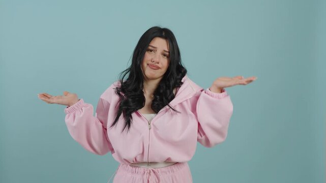 Young woman in pink tracksuit shrugging her shoulders