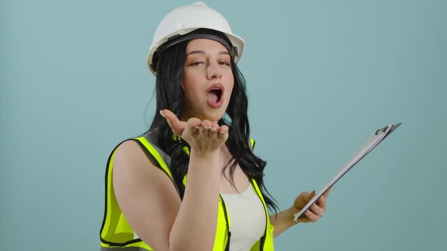 Woman in construction vest winking and blowing a kiss