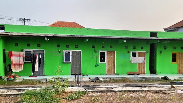 Simple Green Boarding House Architecture with Spacious Yard in Southeast Asia