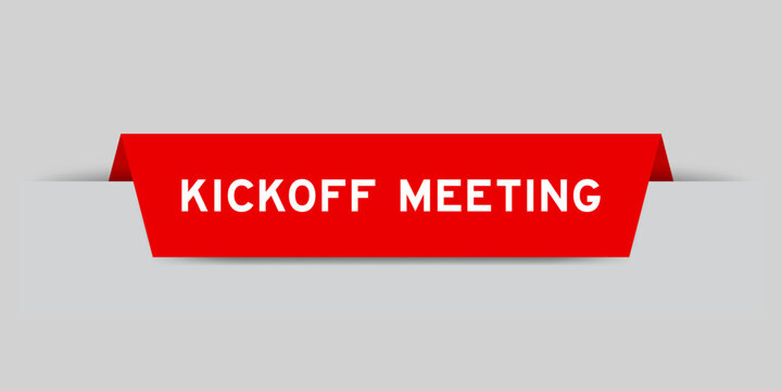 Red color inserted label with word kickoff meeting on gray background