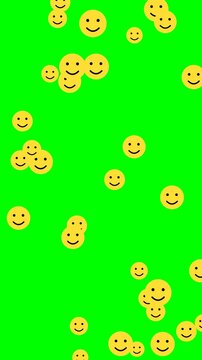 Smiley faces 4k video animation with cheerful yellow icons scattered on green screen background, symbolizing happiness and fun.