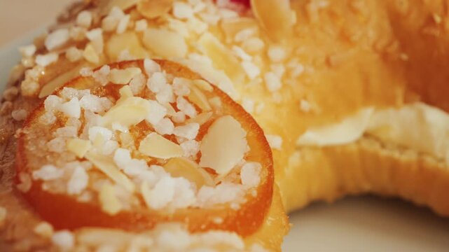 Roscon de reyes. A round pie baked from rich yeast dough and decorated with sugar, almonds and glazed fruits. High quality 4k footage