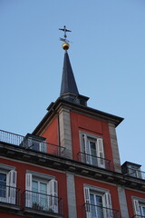 Fototapeta premium Plaza Mayor Madrid Slate Spire Tower with Golden Orb and Cross Against Blue Sky