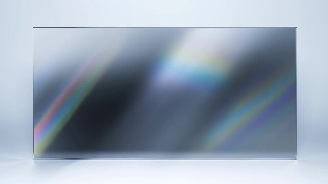 Static shot of glass panel with shifting prism light reflections sliding across rectangular screen on minimalist studio tabletop with clean white background