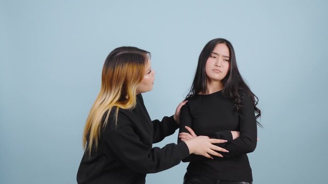One woman trying to calm down her offended and angry friend