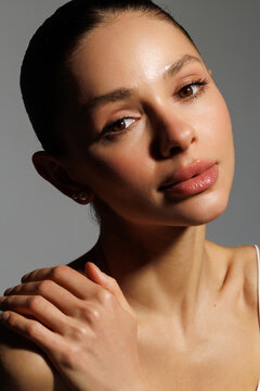 Young woman face with closed eye clean skin on white background