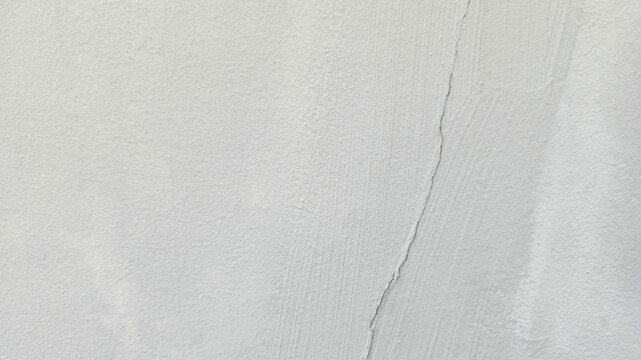 Textured white plaster wall desktop wallpaper with subtle cracks and a rough, matte finish