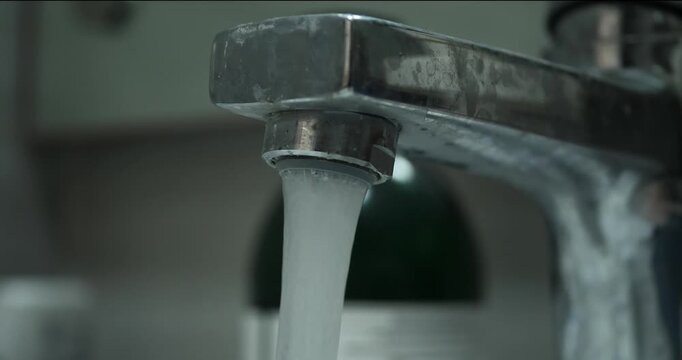 close up of flowing tap water with blurred background