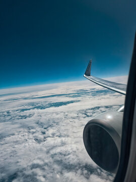 Airplane wing and engine above clouds during Ryanair flight