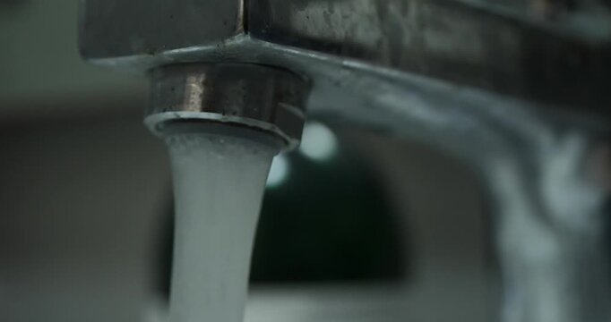 close up of flowing tap water with blurred background