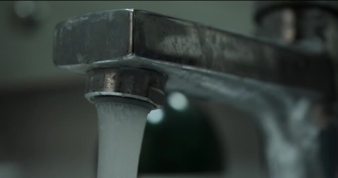 close up of flowing tap water with blurred background