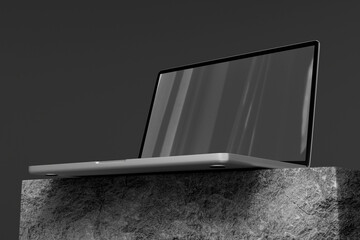 Sleek blank laptop on stone pedestal