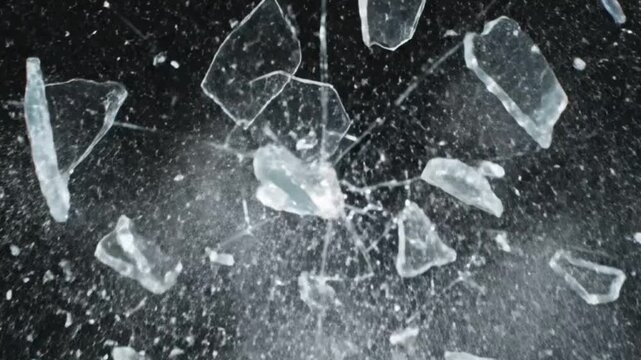 Shattered Glass Explosion on Black Background, Fragile Debris Flying
