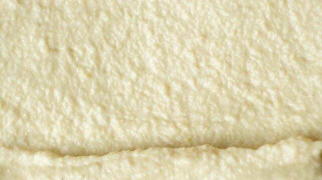 Macro texture of smooth creamy hummus top view