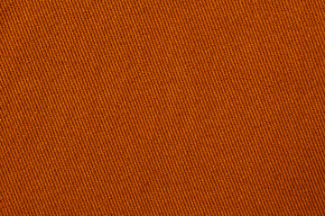 Warm orange denim fabric texture with diagonal twill weave vibrant textile background