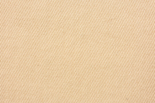 Beige twill fabric texture diagonal weave neutral textile background minimal style
