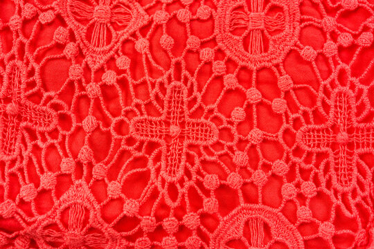 Red lace fabric texture intricate floral pattern decorative textile background close up