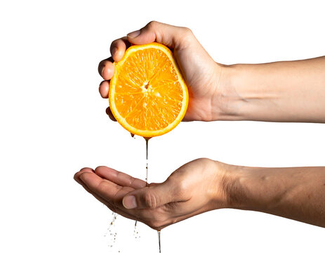 Orange half squeezed by human hands with juice dripping into awaiting palm against a stark, solid black backdrop
