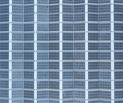 Aerial view of solar panels on the factory roof arranged in a dense geometric grid pattern of blue photovoltaic cells Taiwan.
