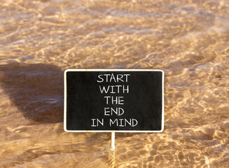 Naklejka premium Start with the end in mind symbol. Concept words Start with the end in mind on beautiful black blackboard. Beautiful sea water background. Business start with the end in mind concept. Copy space.