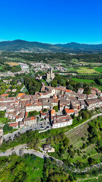 Aerial view of the medieval Castello dei Conti Guidi and the historic rooftops nestled among the green hills of the Casentino valley Poppi, Tuscany, Italy.