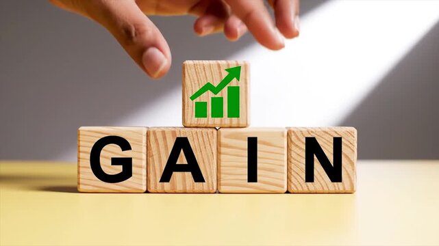 Hand placing growth chart block on wooden gain word for business success concept
