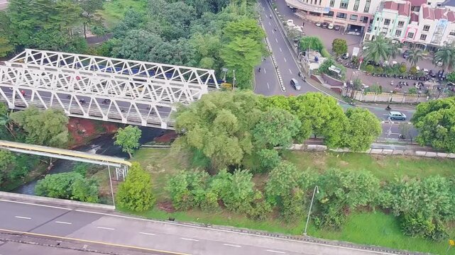 Aerial Drone View of Steel Bridge and Urban Traffic Surrounded by Greenery
