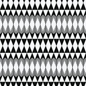 Modern monochromatic seamless pattern featuring repeating tribal triangles and diamond shapes with textured hatching. Ideal for textile and decor.