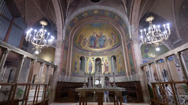 Modena, italy, april 11, 2026. Magnificent interior view of the romanesque modena cathedral in italy. Detailed golden mosaic in the apse above the altar