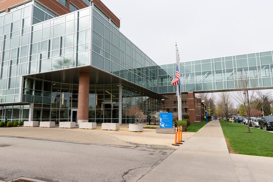 Erie Insurance Headquarters, Erie, Pennsylvania April 17, 2026; Modern glass building with skybridge and American flag on a cloudy day