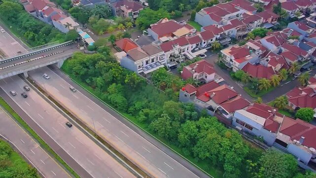 Aerial Drone View of Residential Housing Complex Near Highway in Urban Indonesia