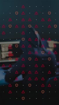 Cyber attack footage of anonymous hacker typing code and breaking database with animated red warning signs and security shields overlay