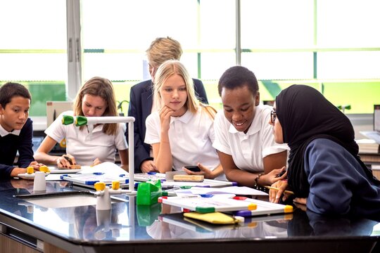 Diverse students collaborating in science.