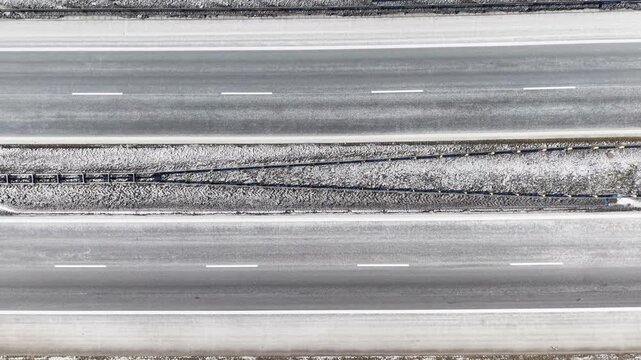 Top down view of S3 expressway covered in snow with passing traffic near Gorz&oacute;w Wielkopolski. Poland