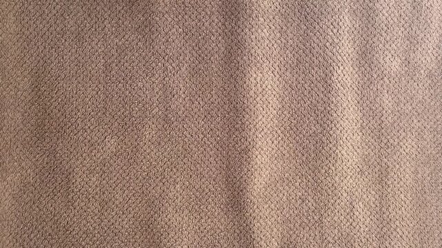 Close-up Shot of Soft Brown Microfiber Fabric with Embossed Diamond Pattern Texture