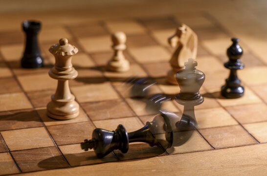 Chessboard with wooden chessmen, checkmate, king falls over, Germany
