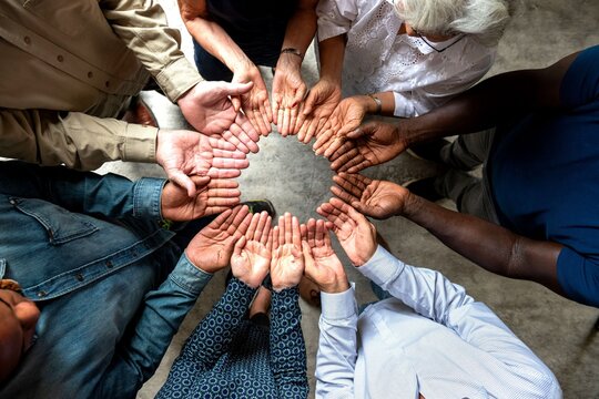 Diverse hands forming unity circle.