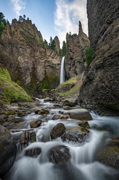 Waterfall flowing through eroded landscape with rock outcrops, Tower Fall with Tower Creek, Yellowstone National Park, Wyoming, USA