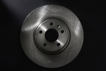 Car brake disc on a black background. Close up view of a car brake disk, for mock up. © Aliaksei