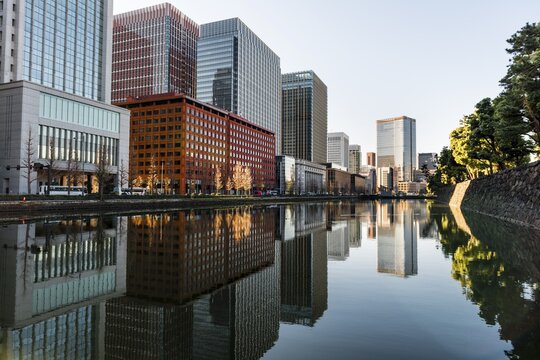 High-rise buildings reflected in a canal, downtown Toyko, at Kokyo Gaien National Garden, Chiyoda-ku, Tokyo, Japan