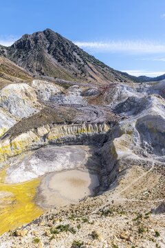 Crater with yellow discoloured sulphur stones and colourful mineral deposits, Caldera volcano with pumice fields, Alexandros crater, Nisyros, Dodecanese, Greece