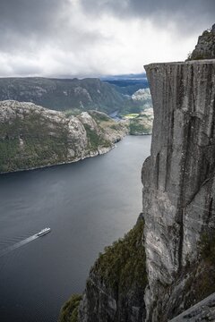 Rock plateau, rock pulpit Preikestolen, boat on the Lysefjord, Ryfylke, Rogaland, Norway