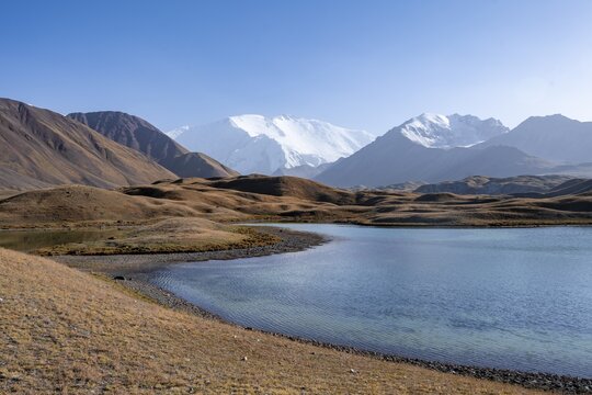Mountains reflected in a small mountain lake, Pik Lenin, Trans Alay Mountains, Pamir Mountains, Osh Province, Kyrgyzstan